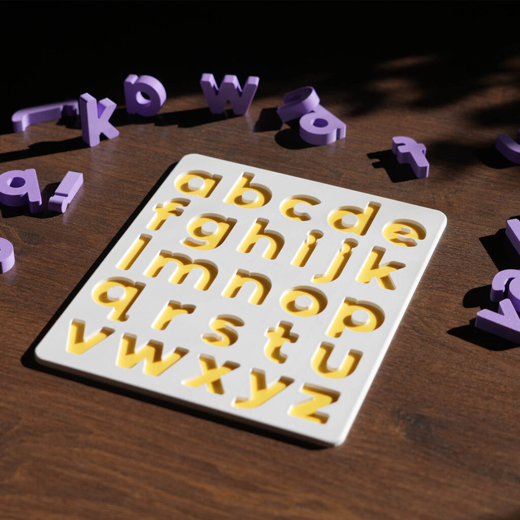 Montessori-style alphabet puzzle on a playmat