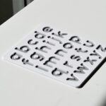 White and grey lowercase alphabet puzzle for preschoolers – educational toy for early literacy and letter recognition.