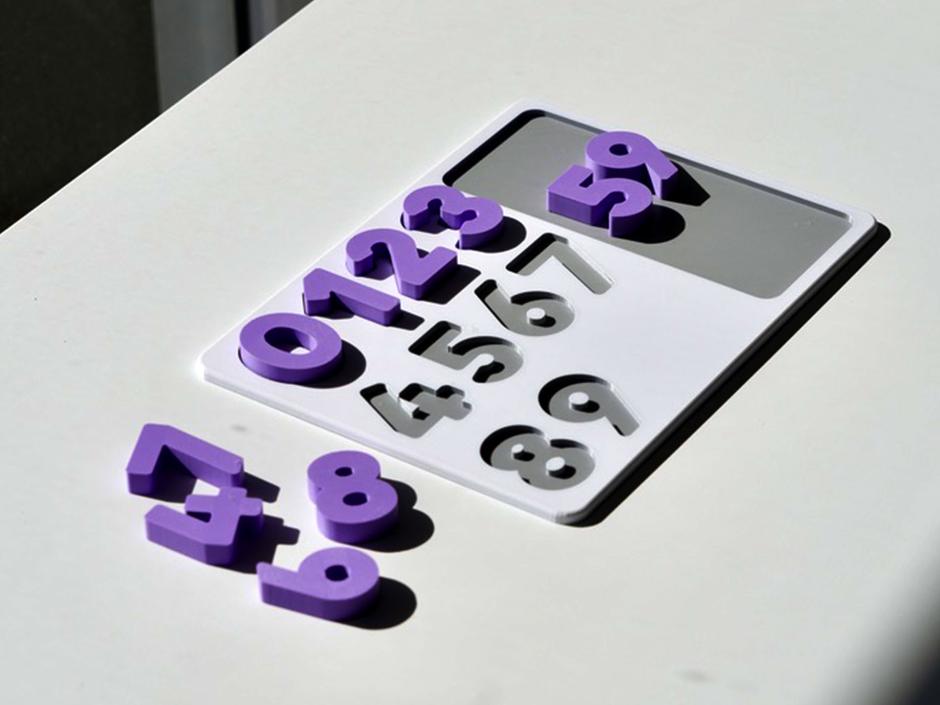 Number puzzle pieces scattered – hands-on counting toy promoting number recognition and early math skills.