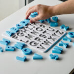 Uppercase alphabet puzzle with letters being placed – interactive learning toy supporting preschool literacy and fine motor skills.