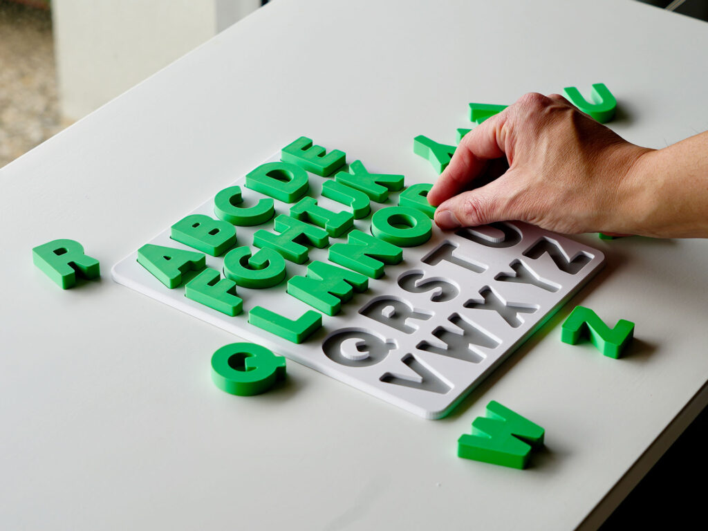 Uppercase alphabet puzzle with letters being placed – interactive learning toy supporting preschool literacy and fine motor skills.