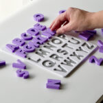 Uppercase alphabet puzzle with letters being placed – interactive learning toy supporting preschool literacy and fine motor skills.