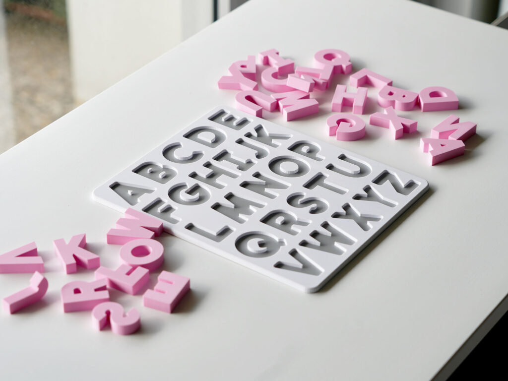 Uppercase alphabet puzzle with scattered letters – hands-on educational toy for letter recognition and early literacy skills.
