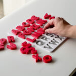 Uppercase alphabet puzzle with letters being placed – interactive learning toy supporting preschool literacy and fine motor skills.