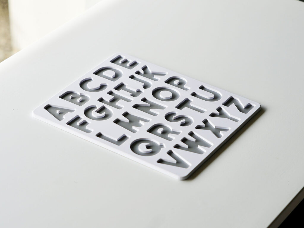 Uppercase alphabet puzzle base in white and grey – Montessori-inspired educational toy for preschool letter learning.