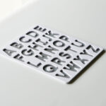 Uppercase alphabet puzzle base in white and grey – Montessori-inspired educational toy for preschool letter learning.